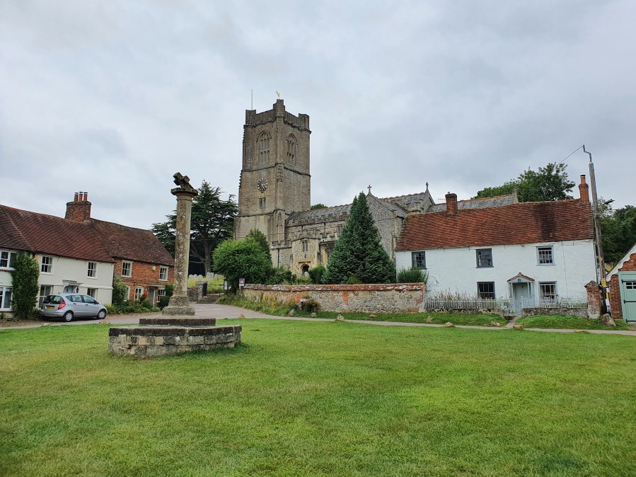 Village green and war memorial in front of the church at Aldbourne