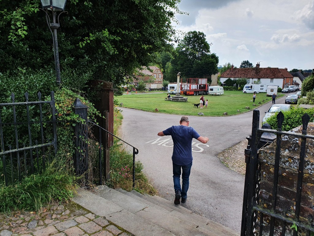 Man running away from the Church towards the village green.
