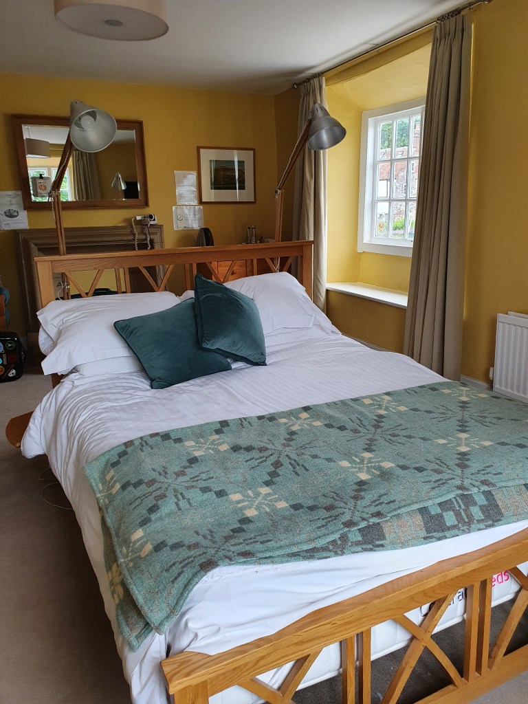 Double bed with lamps either side of headboard. 

