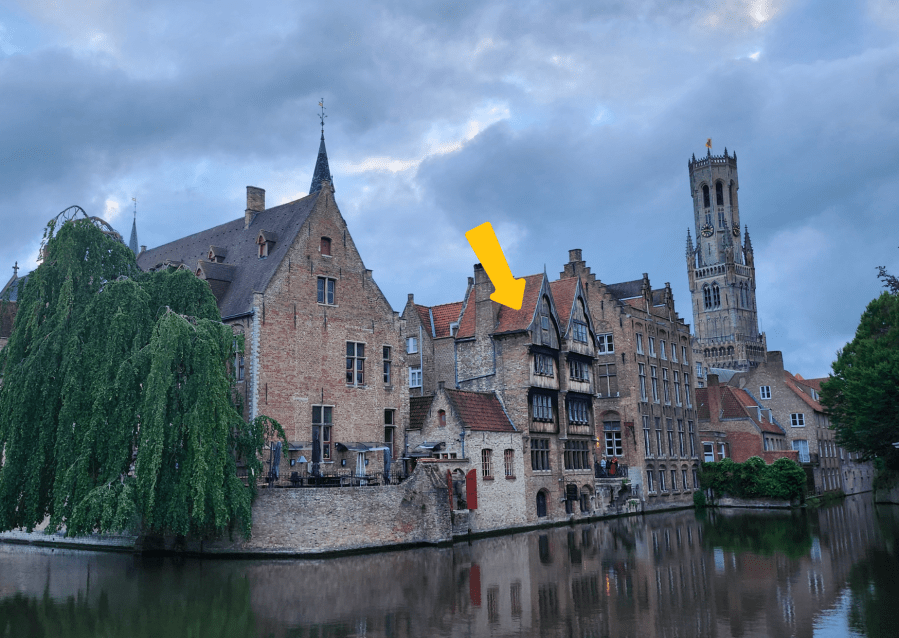 Old buildings by a canal. One window is highlighted.