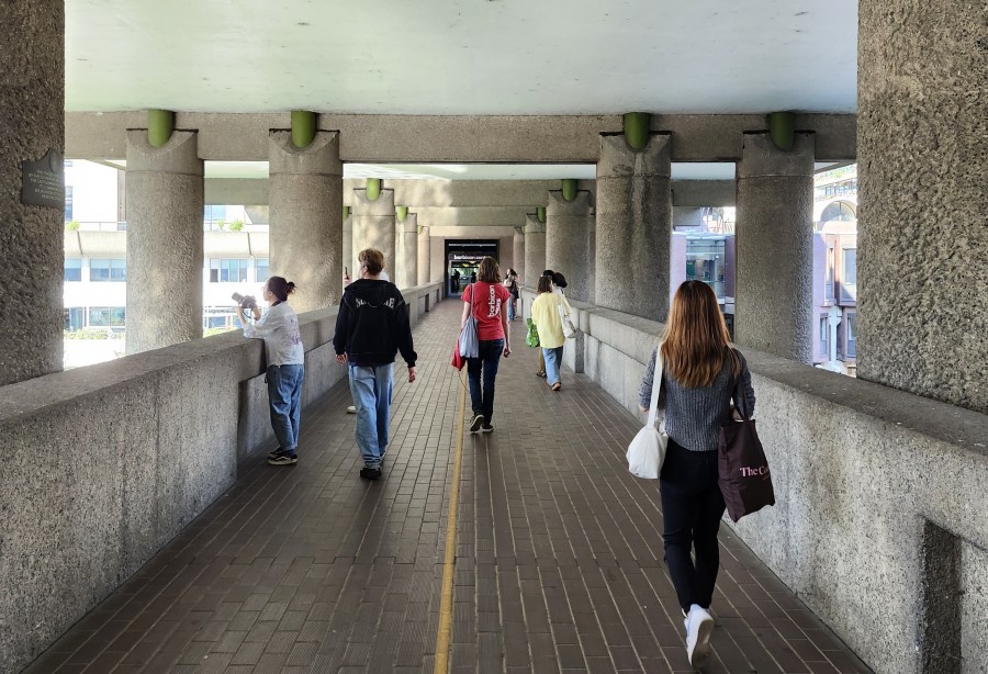 Group of people viewed from the back, person in middle is wearing a Barbican tour t'shirt